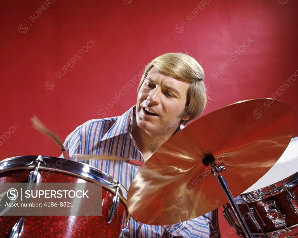1970S Blond Man Striped Shirt Red Background Playing Drums Drum Drumming Cymbal Percussion Music Musician Rhythm
