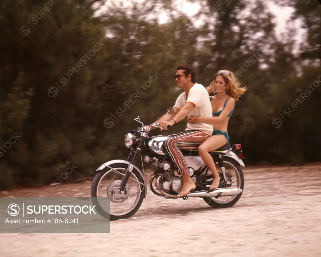 1970S Barefoot Couple Man Woman Wearing Beach Clothing Riding Motorcycle