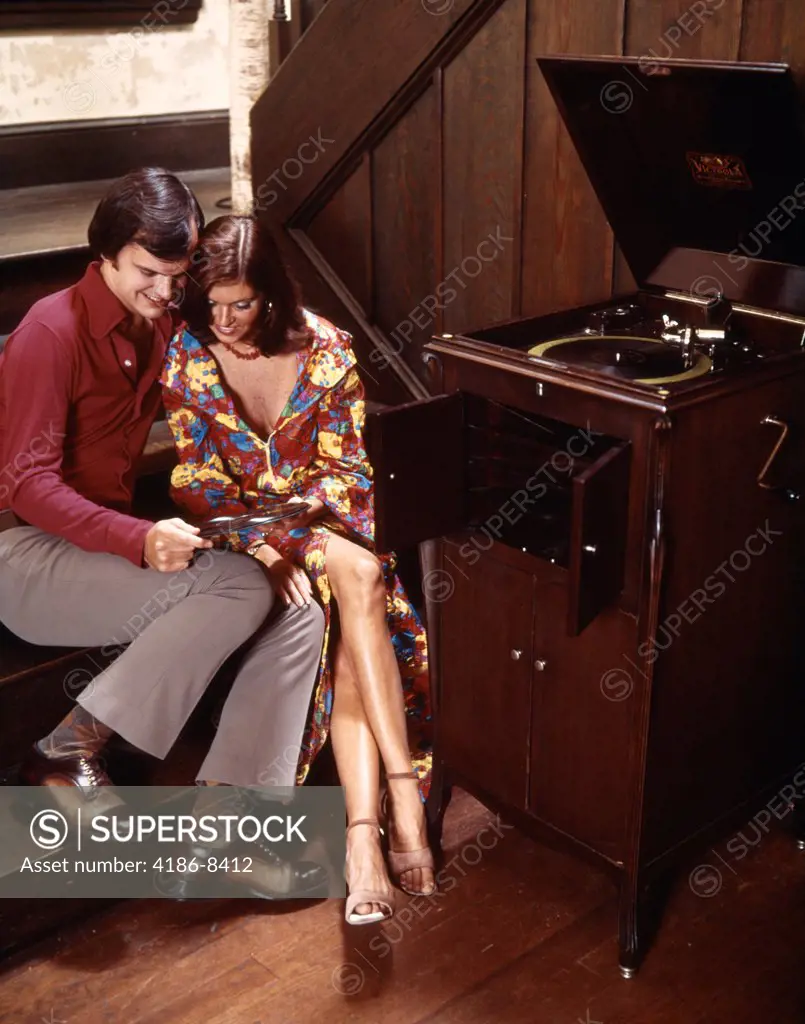 Couple Sitting Close Together Listening To Audio Record Player Husband Wife Indoor 1970S 