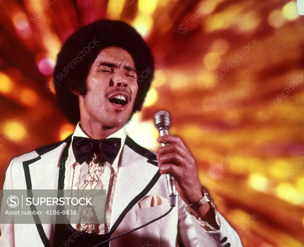1970S African-American Man Singer White Tuxedo Ruffled Shirt Singing Into Microphone  