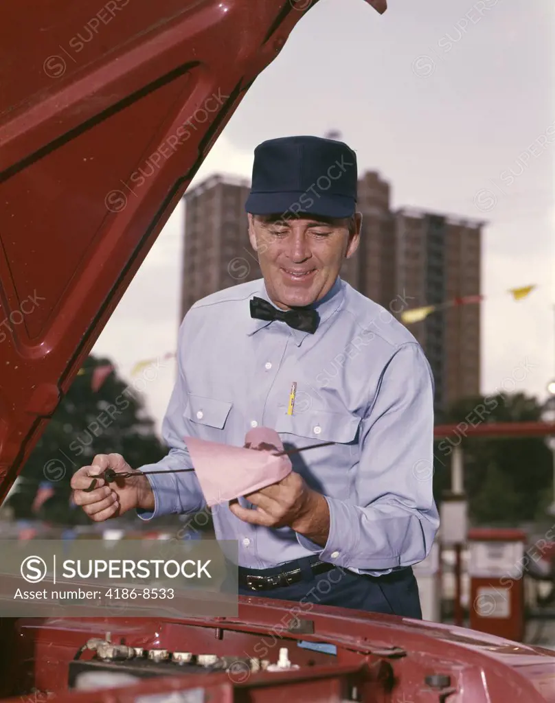 1960S Garage Service Station Attendant In Uniform Checking Car Oil Dip Stick