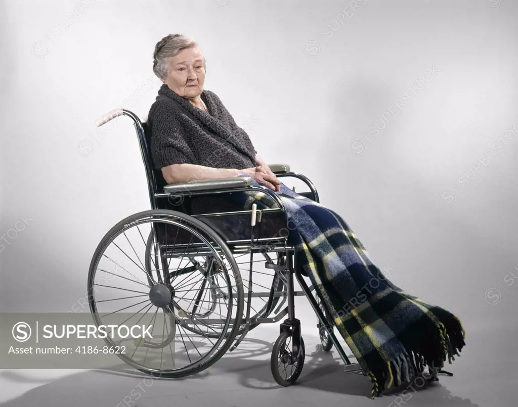 1960S Sad Senior Woman Sitting In Wheelchair Shawl On Shoulders And A Plaid Lap Blanket