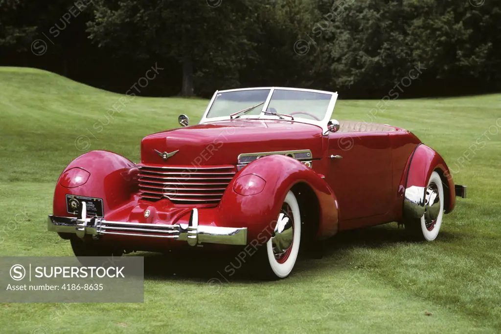 1930S 1936 Red Cord Convertible Automobile Top Down On Green Grassy Lawn