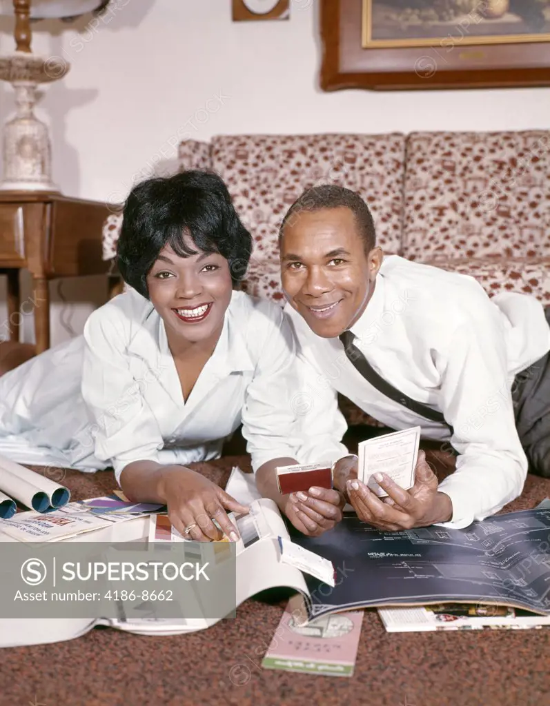 1960S 1970S African American Couple Man Woman Husband Wife Together Planning Home Improvements Smiling