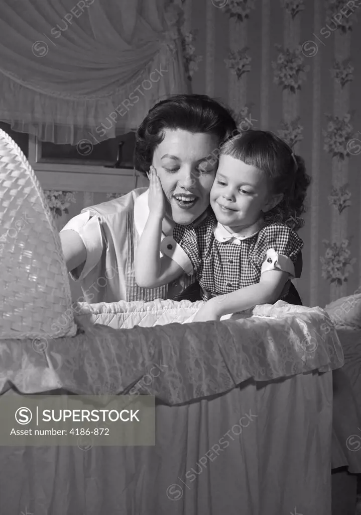 1950S Mother & Daughter Admiring Baby In Bassinet