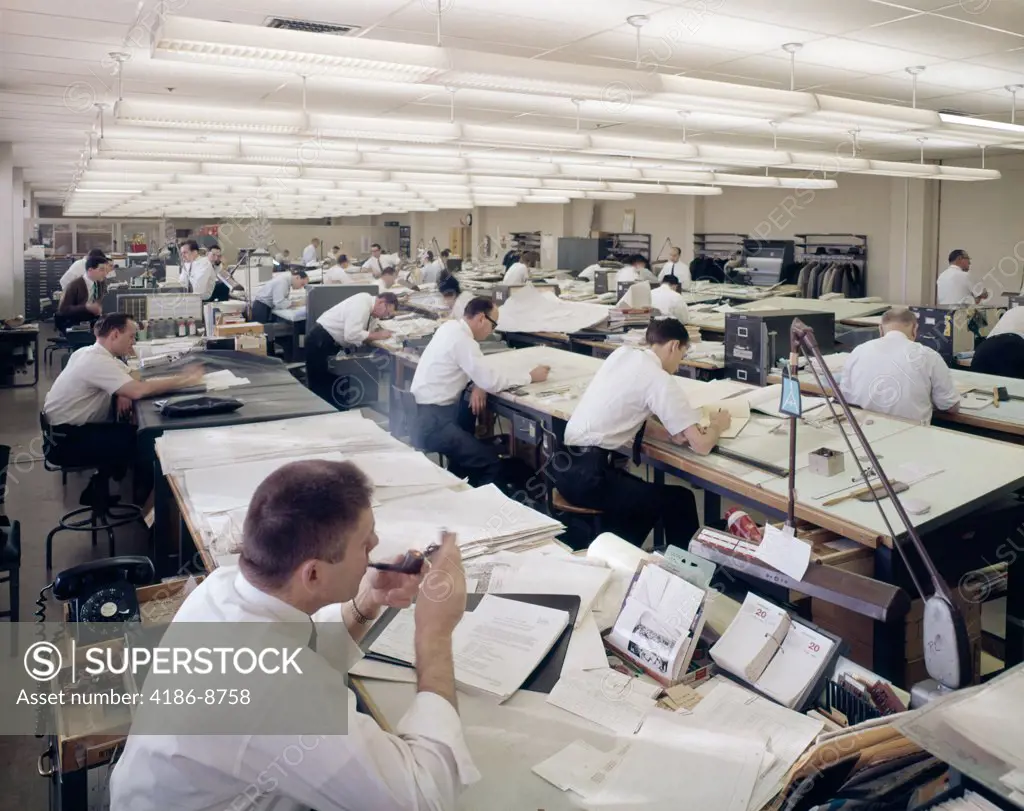 1960S Office Full Of Drafting Tables Designer Man Lighting-Up A Pipe Of Tobacco Indoor Industry 