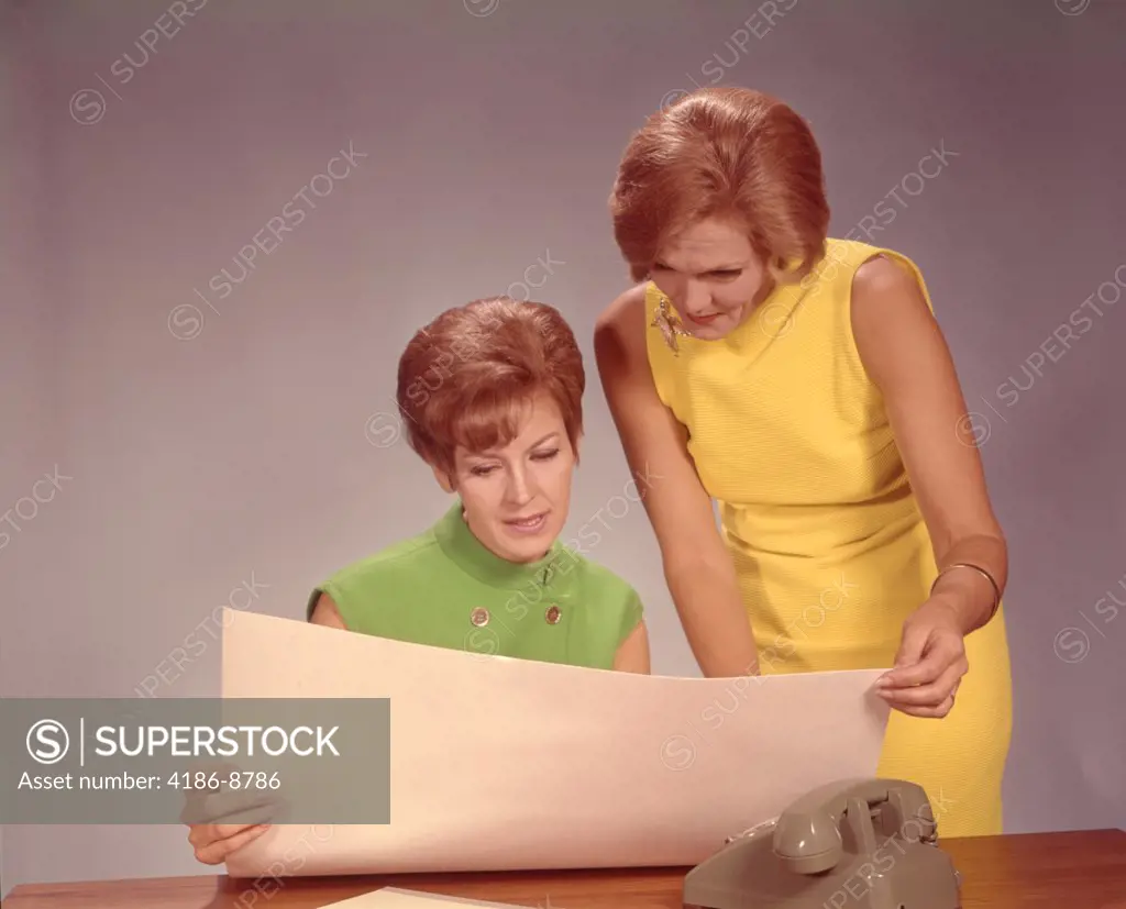 1960S Two Women Executives At Desk With Telephone Looking At Worksheet