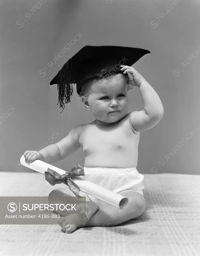 1940S Baby Wearing Mortar Board Graduation Cap And Holding Diploma