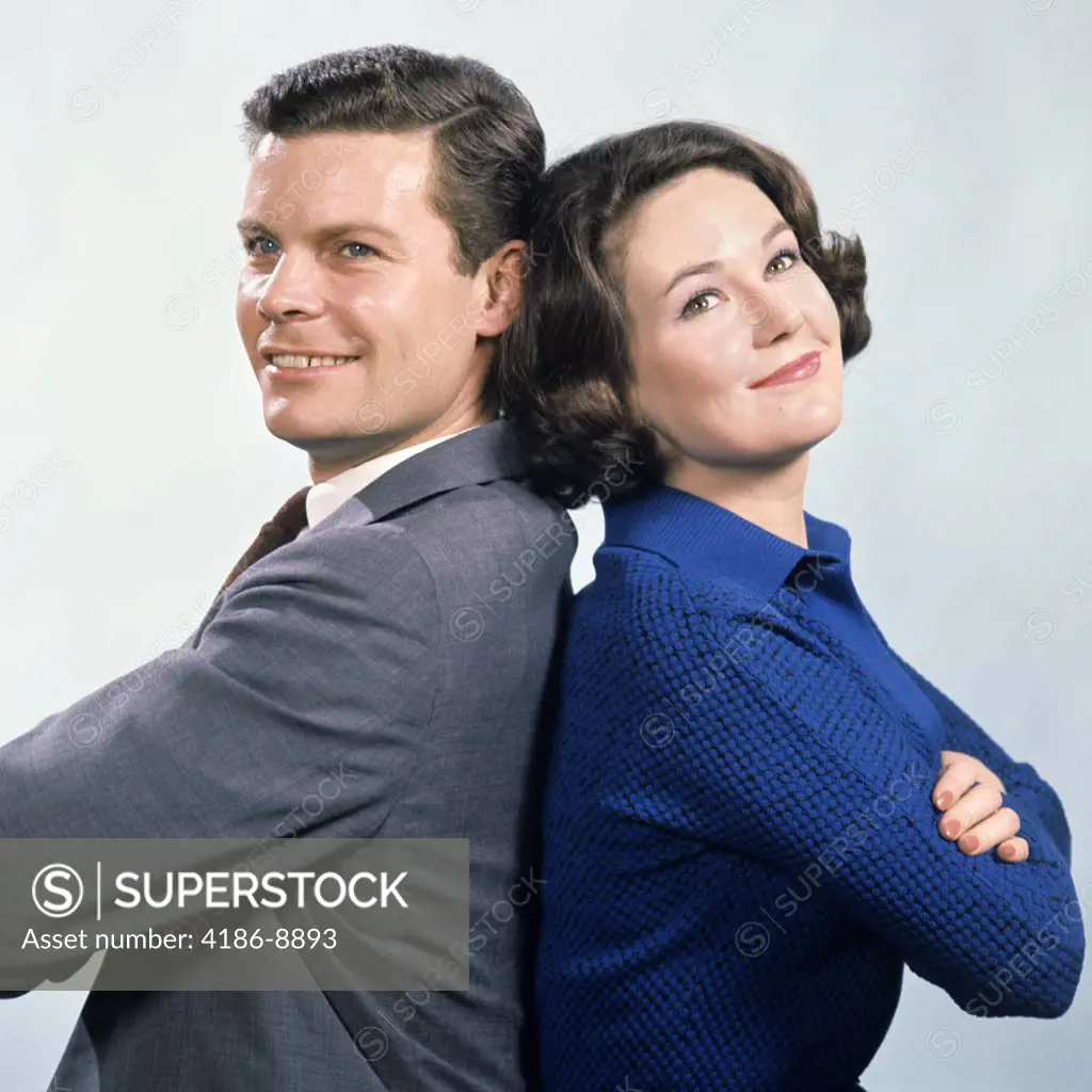 1960S Smiling Couple Man And Woman Standing Back To Back With Arms Folded