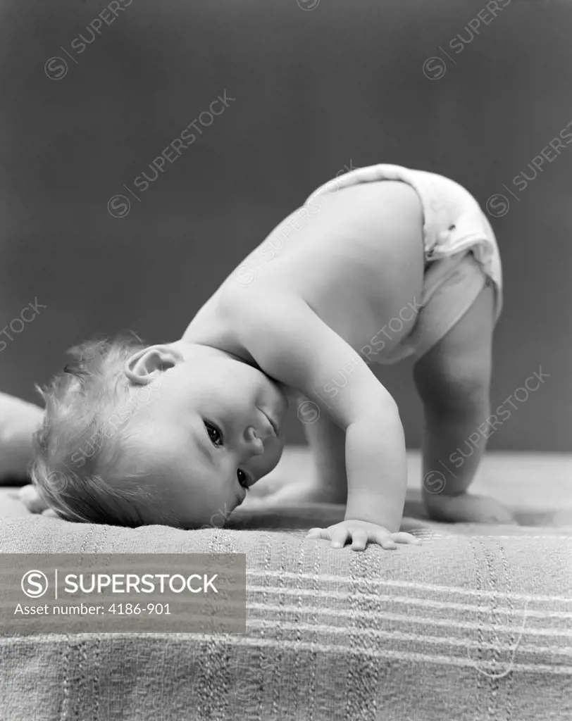 1940S Baby Bending Down With Head On Blanket