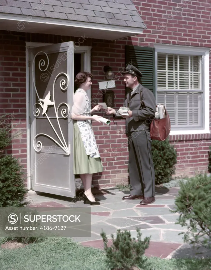 1950S Mailman Delivering Mail To Woman Brick Suburban Home