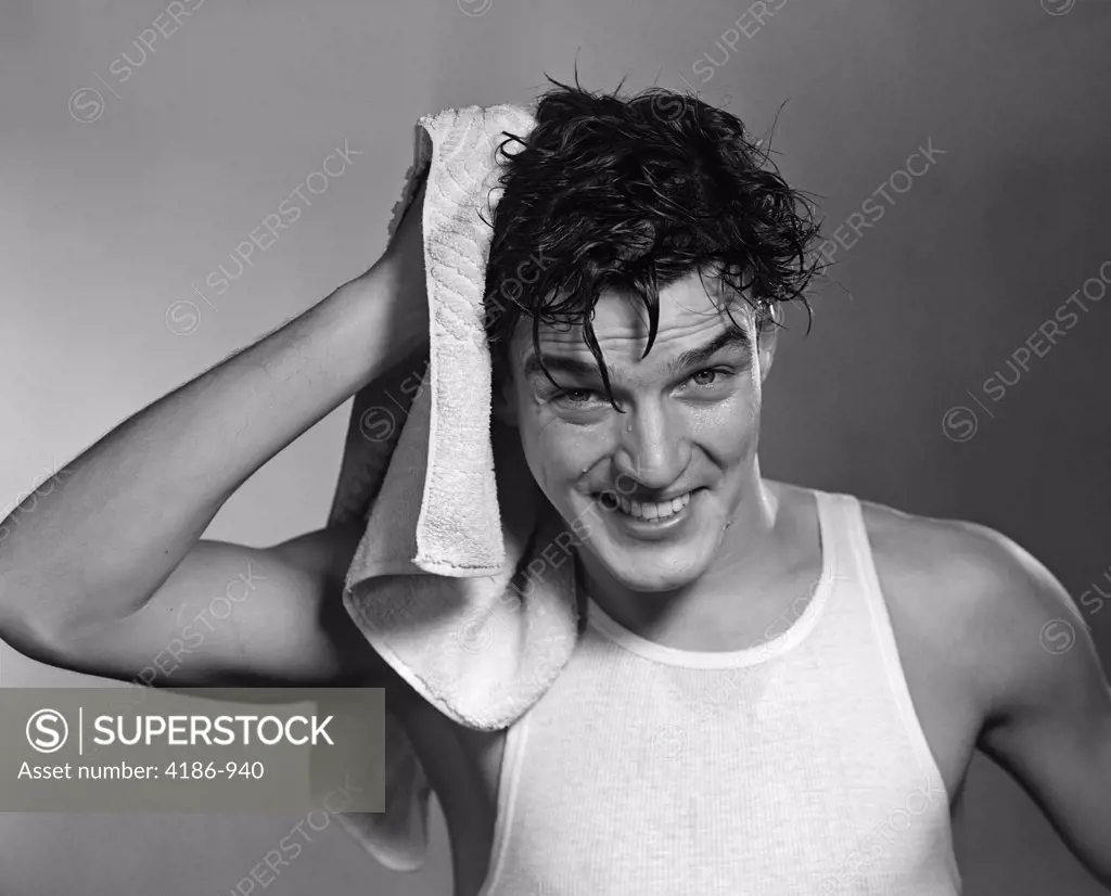 1950S Man Drying Hair After Shower Shampoo Wearing Tee Shirt Looking At Camera
