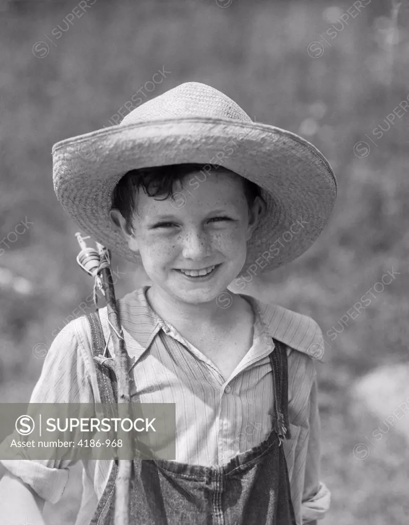 1930S Smiling Boy In Overalls & Straw Hat With Fishing Pole Slung Over Shoulder