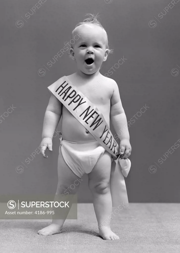 1940S Baby Standing In Diaper Yawning Wearing Happy New Year Sash