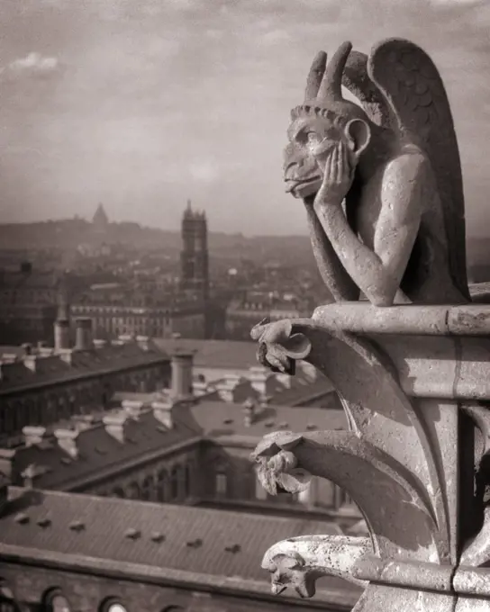 1920s NOTRE DAME CATHEDRAL STONE GARGOYLE CHIMERA OVERLOOKING SKYLINE OF PARIS FRANCE