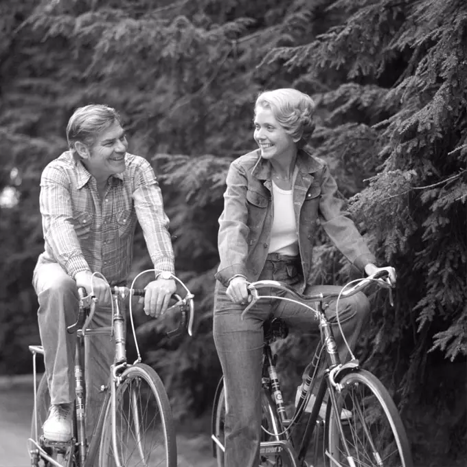 1970S Happy Smiling Active Mature Middle-Aged Couple Riding Bicycles Bikes Pine Wooded Trail Activity Sports Retire Exercise