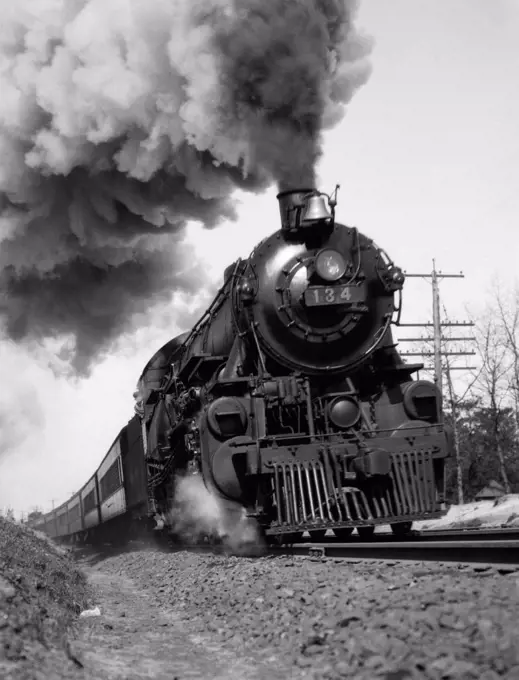 1920S 1930S Steam Engine Pulling Passenger Train Smoke Billowing From Exhaust Stack