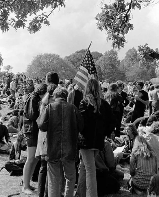 1970S Back View Of Crowd Of Young Men & Women Teenage Students Participating In Protest Demonstration Holding American Flag
