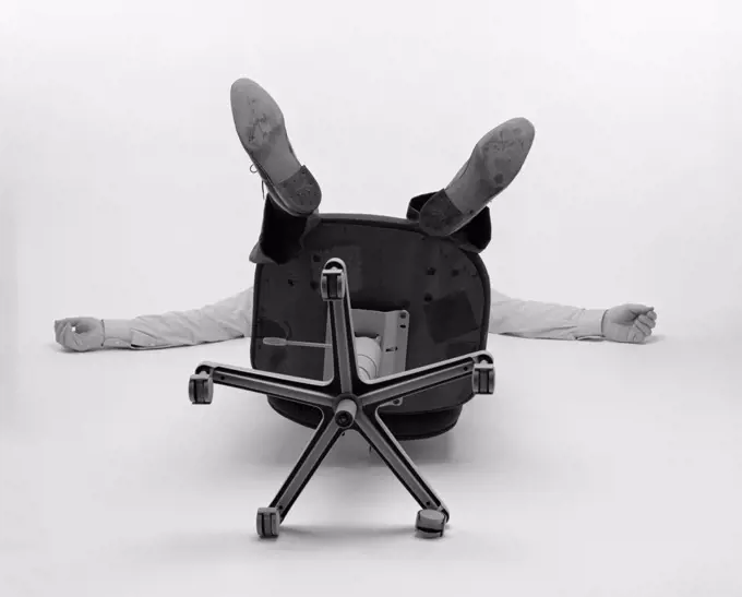 1980S Man Only See Arms Legs Bottom Of Office Chair Fallen Over Backwards
