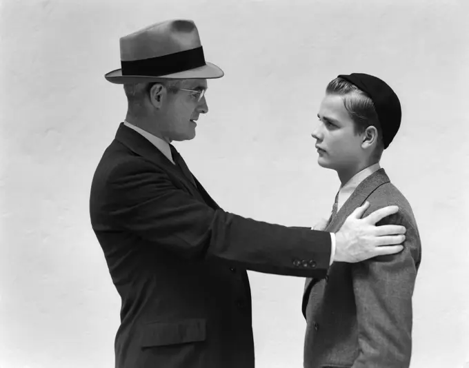 1940S Man And Boy Father Son Facing Each Other Both In Hats And Suits