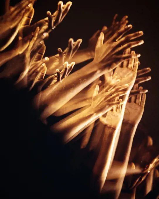 1970s MULTIPLE EXPOSURE OF AFRICAN-AMERICAN CLAPPING HANDS AND ARMS UPLIFTED RAISED IN INVOCATION PRAISE PROTEST OR APPLAUSE