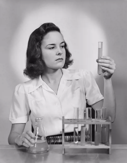 1940S Young Woman Chemist Holding Up Test Tube