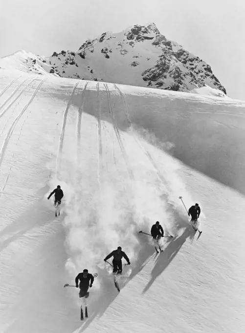 1920S 1930S Five Men Skiing Down Snow Covered Alps Switzerland