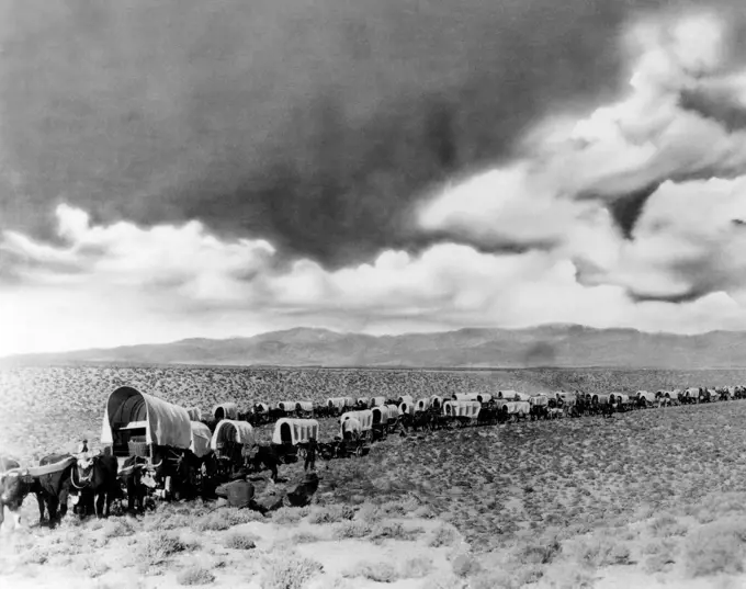 1870s 1880s MONTAGE OF COVERED WAGONS CROSSING THE AMERICAN PLAINS