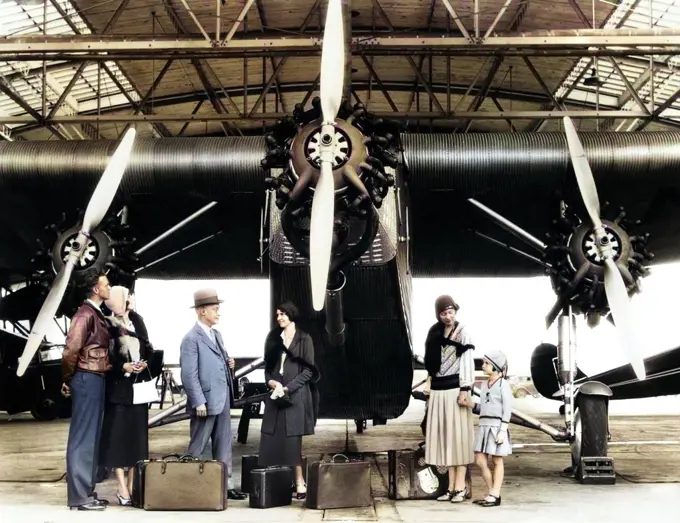 1920s 1930s GROUP OF PASSENGERS WAITING IN FRONT OF FORD TRI-MOTOR AIRPLANE