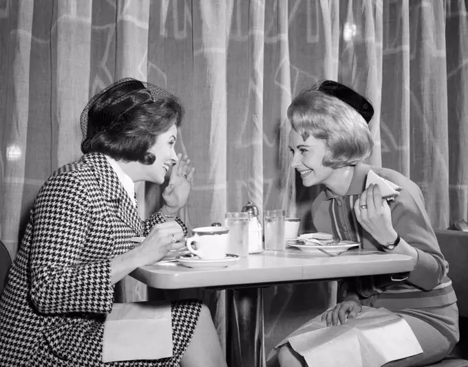 1960S Women Gossiping At Lunch In Restaurant