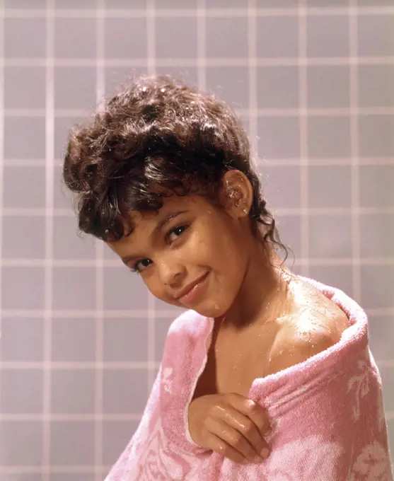 1970s SMILING AFRICAN AMERICAN TEENAGE GIRL WRAPPED IN SHOWER BATH TOWEL LOOKING AT CAMERA
