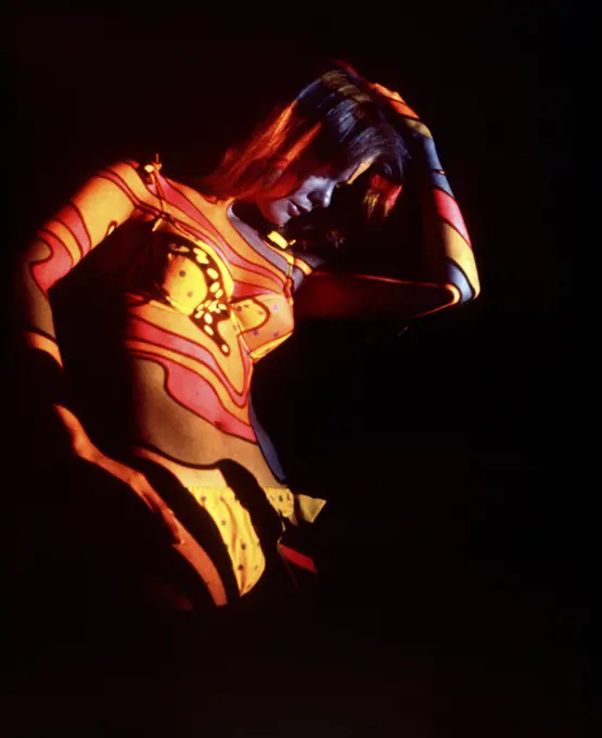 1970s COLORFUL PSYCHEDELIC PATTERN LIGHTS COLORS PROJECTED ONTO WOMAN BODY WEARING BIKINI DISCO DANCER
