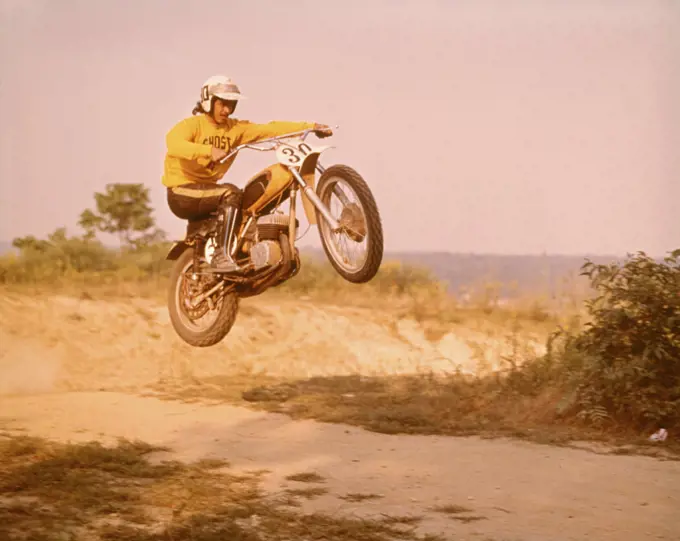 1970s MOTORCYCLE CROSS COUNTRY RACE MAN ON BIKE NUMBER 30 JUMPING IN AIR
