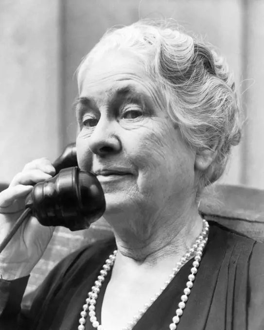 1930s 1940s OLD WOMAN ON TELEPHONE HEAD AND SHOULDERS GRAY HAIR PEARLS LOOKING AT CAMERA
