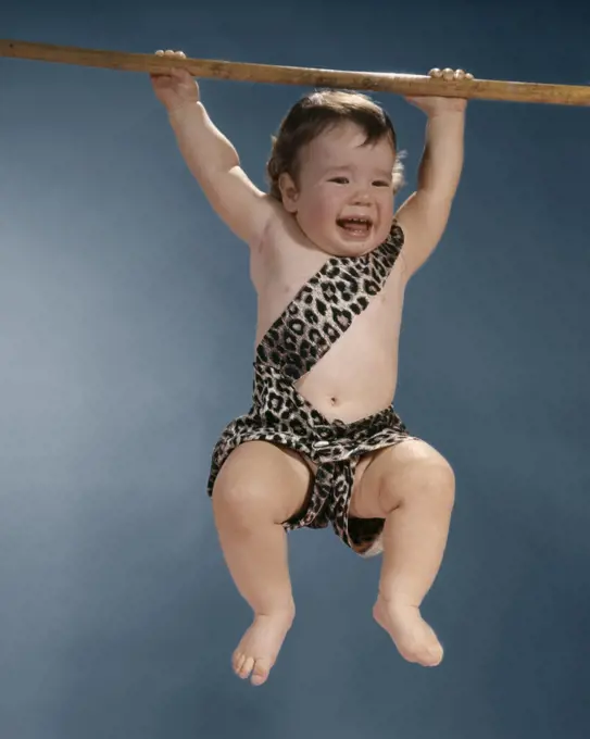 1960S CRYING BABY IN LEOPARD SKIN TARZAN SUIT SWINGING FROM A BRANCH
