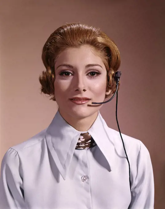 1960s 1970s PORTRAIT SERIOUS WOMAN TELEPHONE OPERATOR WEARING HEADSET MICROPHONE LOOKING AT CAMERA