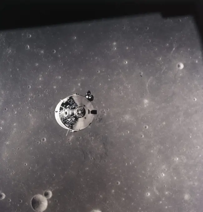 1960s JULY 1969 APOLLO 11 COMMAND MODULE OVER THE SURFACE OF THE MOON
