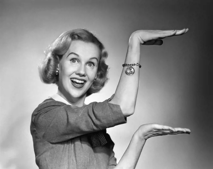 1950S 1960S Happy Smiling Blond Woman Gesturing With Hands Showing Size Of Something Looking At Camera