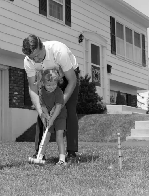 1960S Father And Young Daughter Playing Croquet In  Yard