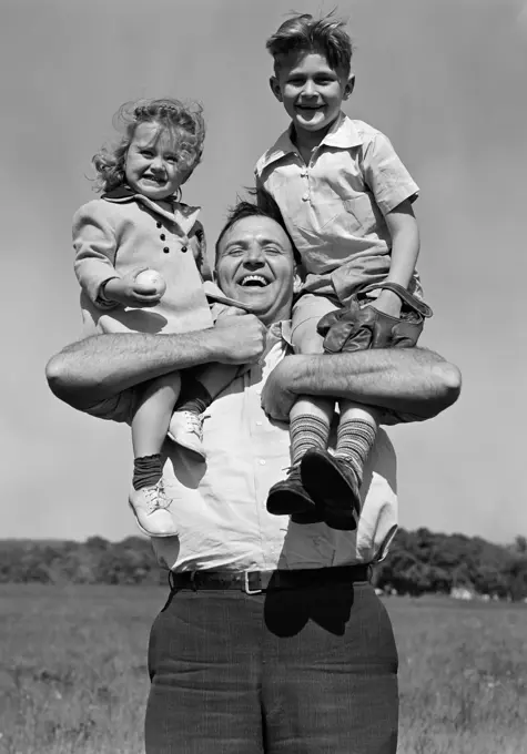 1930S Smiling Father Holding Son With Baseball Mitt & Daughter On His Shoulders