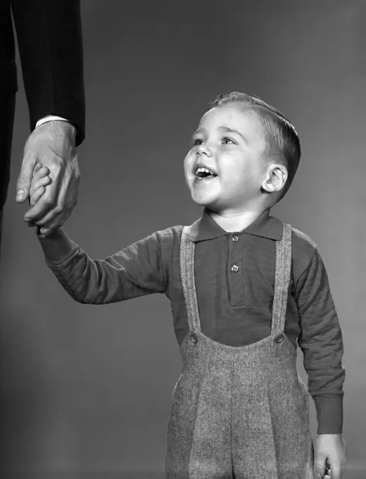 1960S Boy Holding Adult Male Hand Smiling