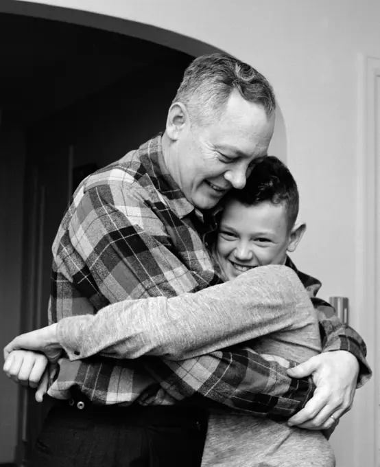1950S 1960S Smiling Father And Son Hugging Indoor
