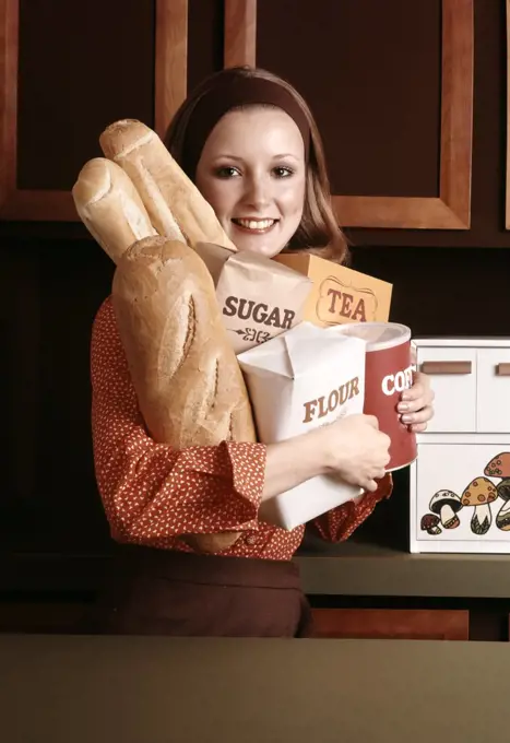 1970S Smiling Woman Housewife Arm Full Of Basic Kitchen Food Supplies Bread Flour Sugar Tea Coffee Staples Groceries