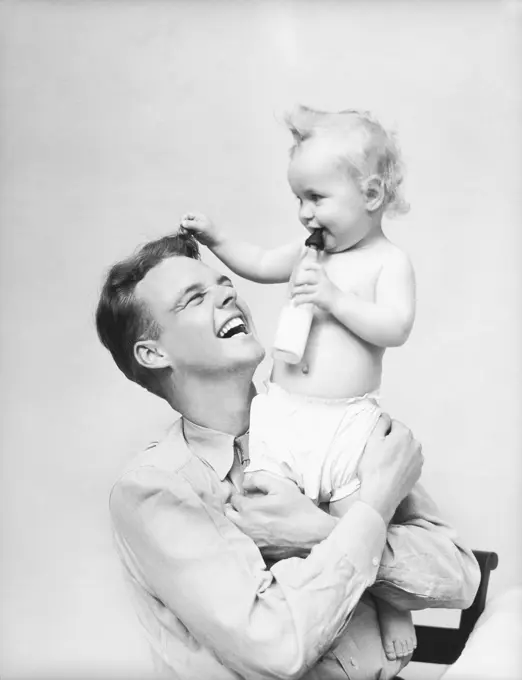 1930S Father Holding Baby In Arms Smiling Milk Bottle