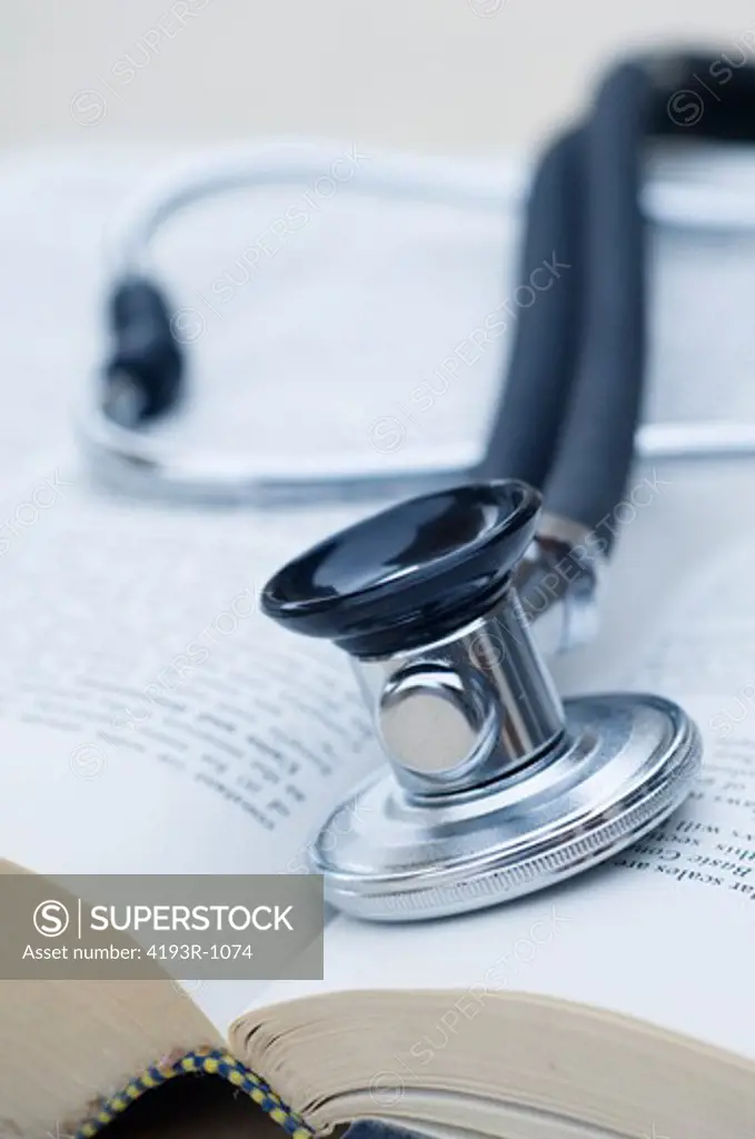 Stethescope resting inside an open medical book