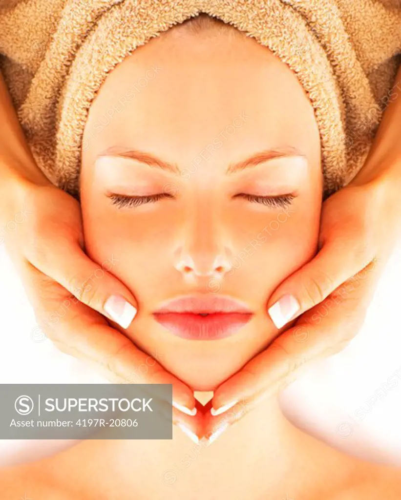 Beautiful young woman receiving facial massage