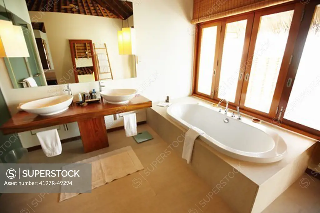 Wide-angle view of a tiled bathroom