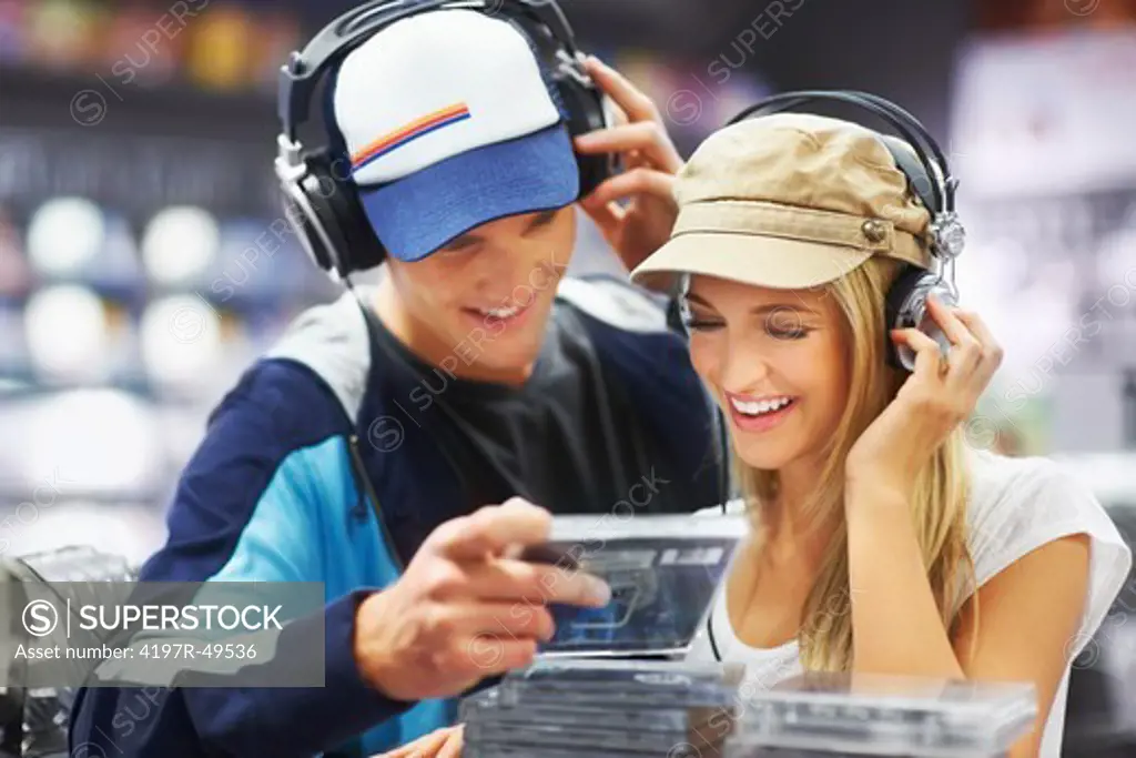 A trendy music-loving couple enjoying songs together at their favourite CD store