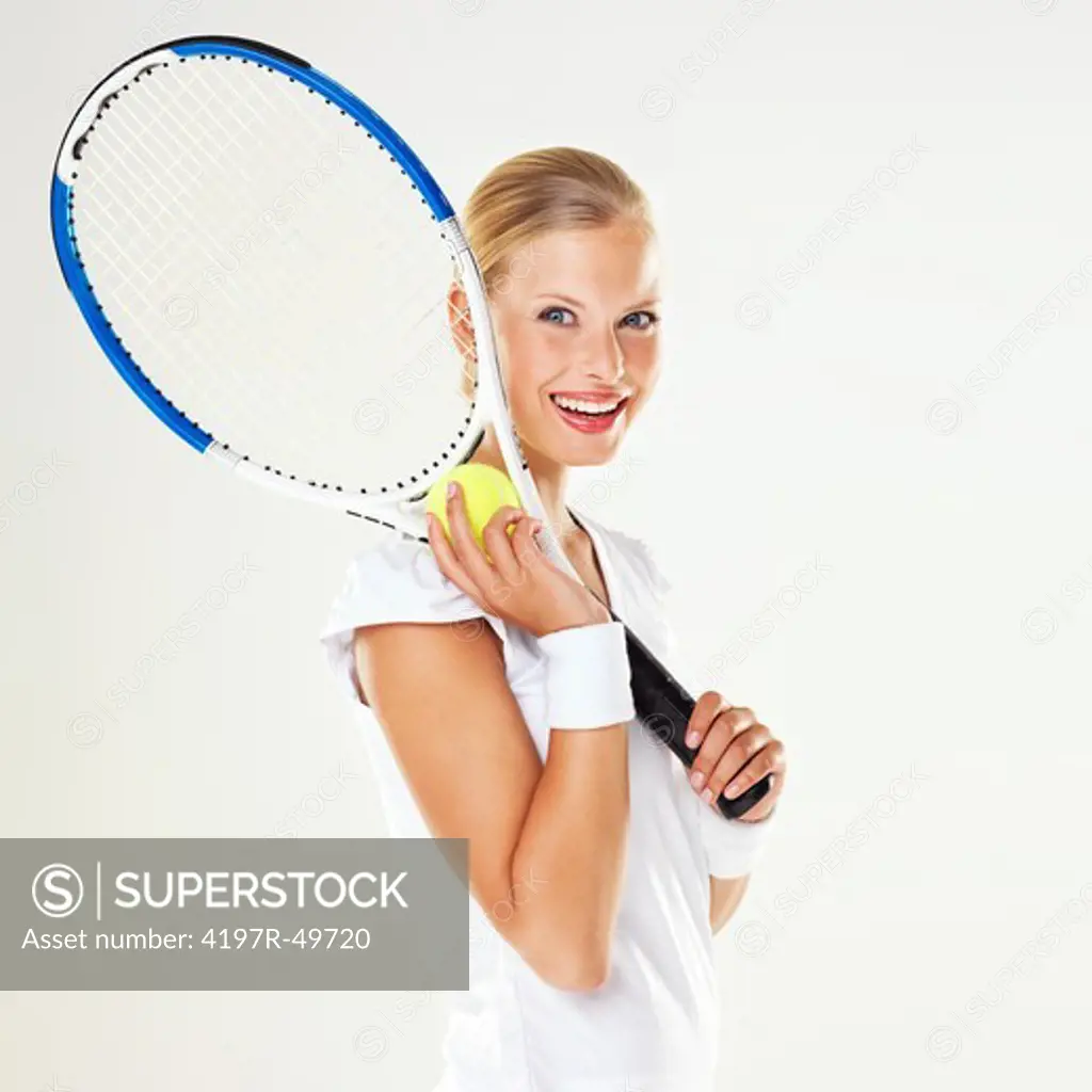 Portrait of a young female tennis player with her racquet over her shoulder