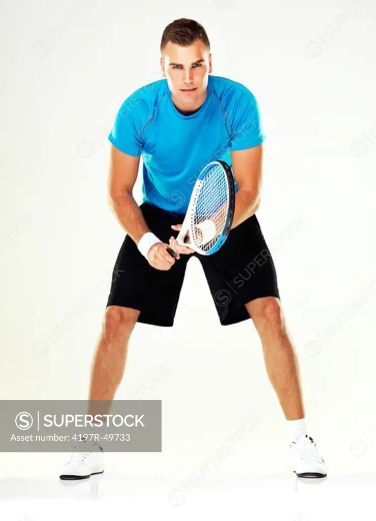 Portrait of a young male tennis player standing ready for the serve